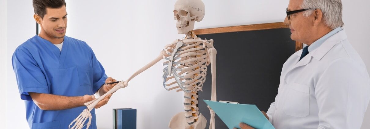 Medical professionals studying anatomy in a classroom
