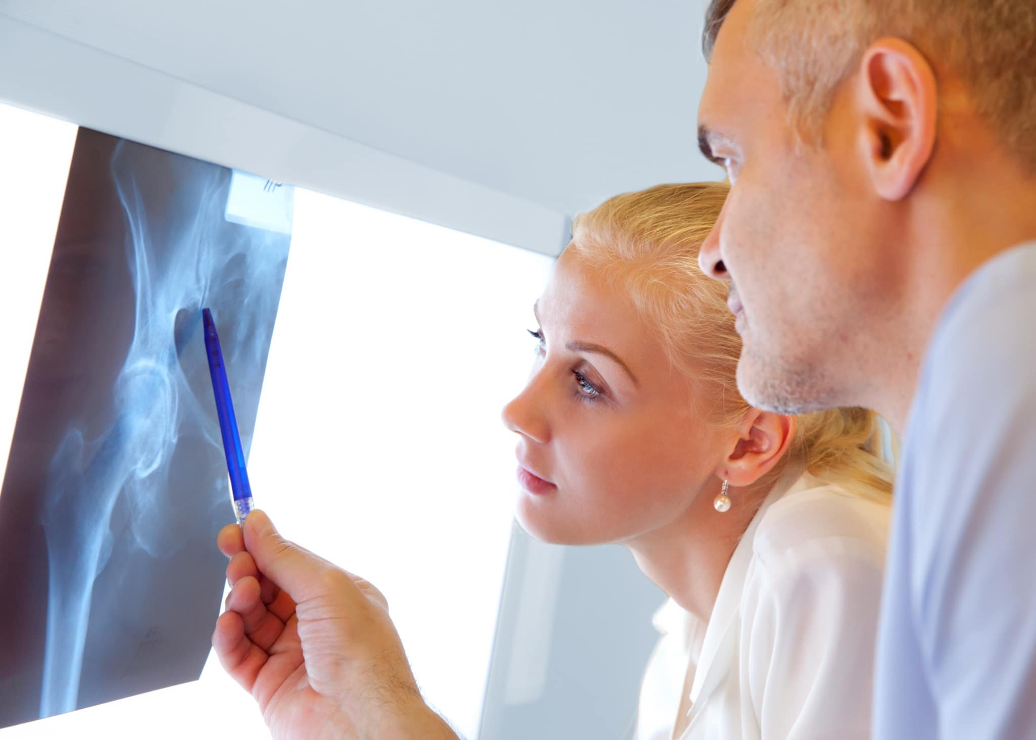 Two orthopedic nurses examining X-rays