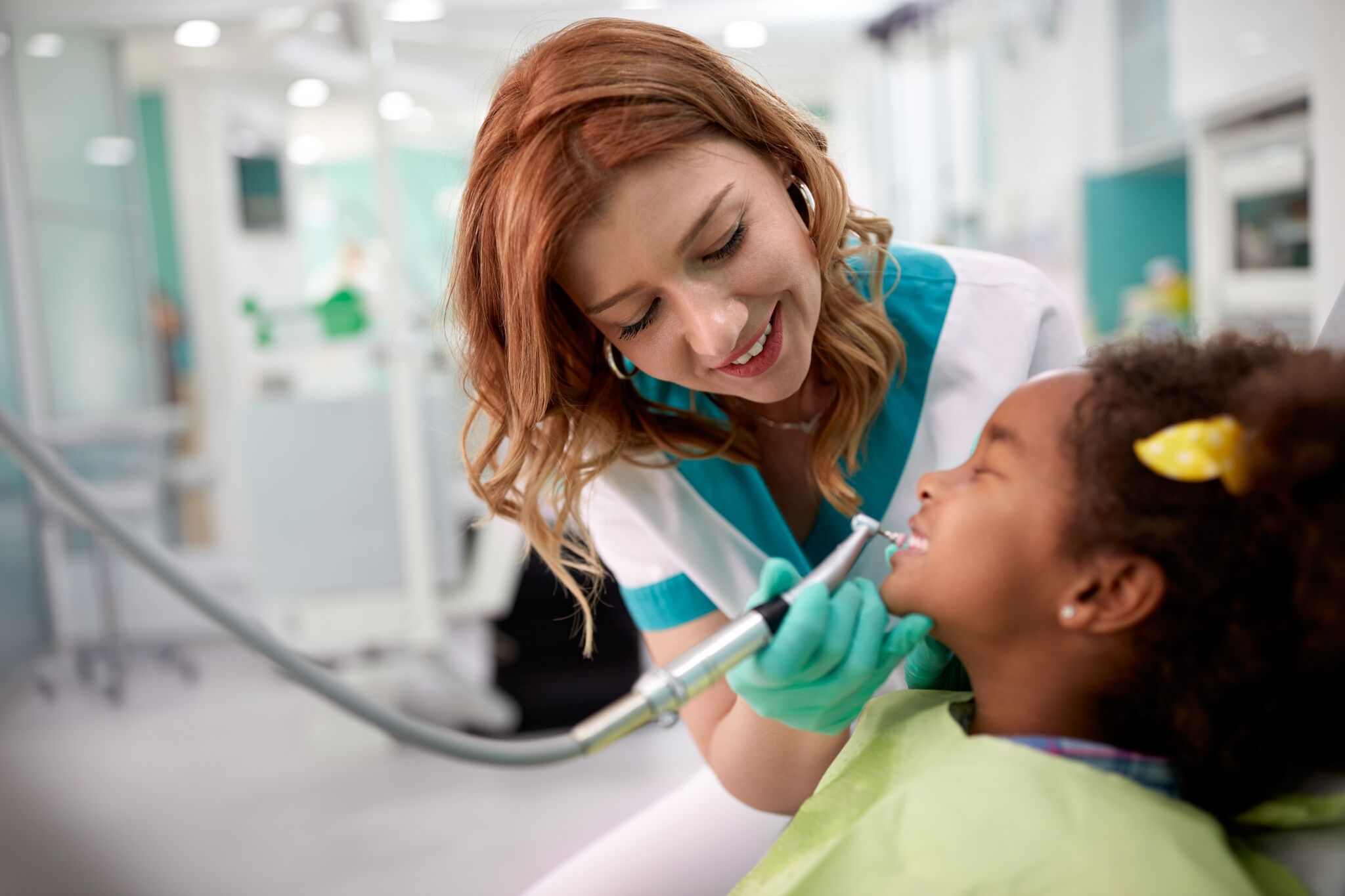 Smiling professional assisting with a dental exam