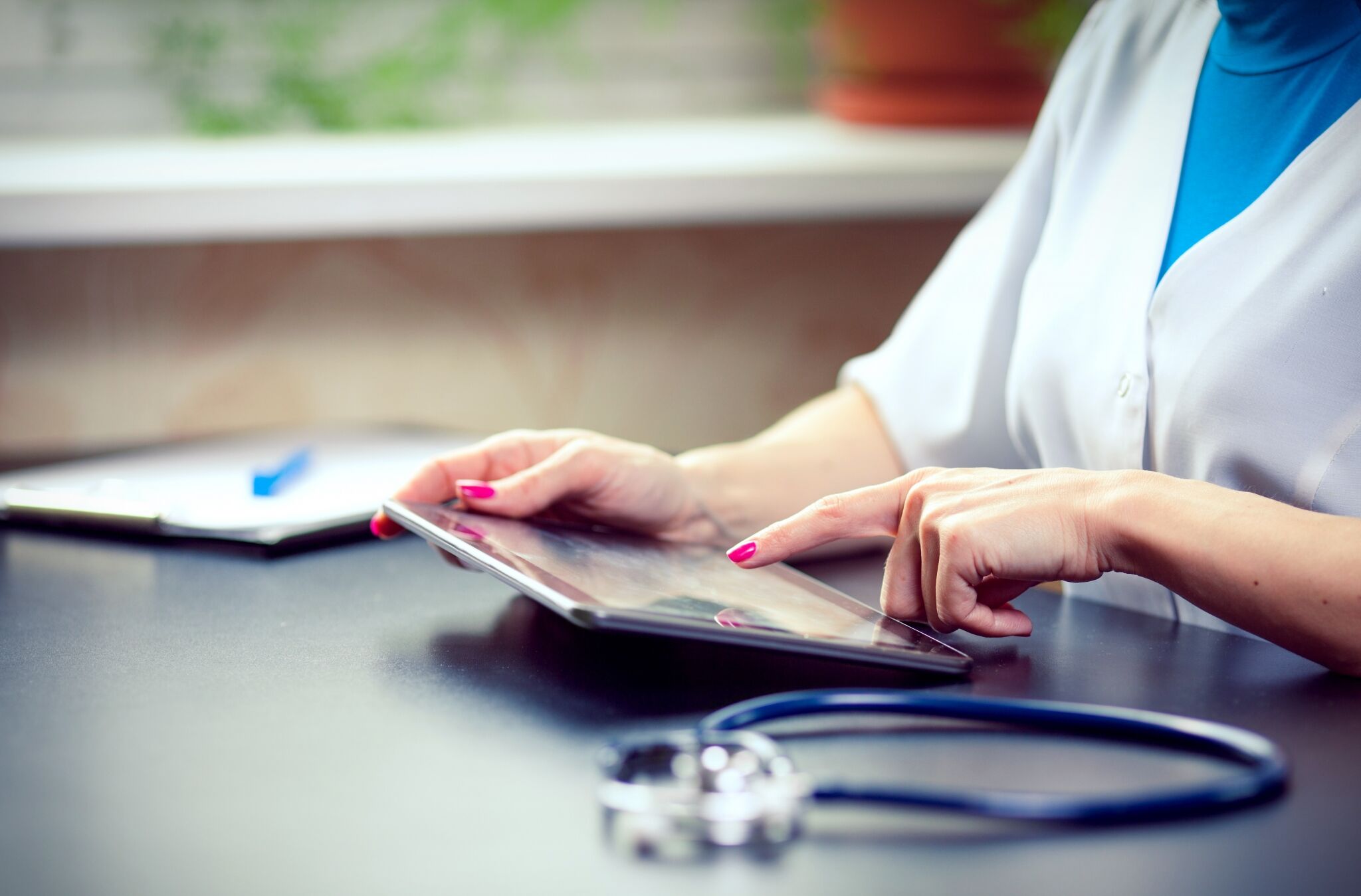 A woman with a stethoscope on a tablet