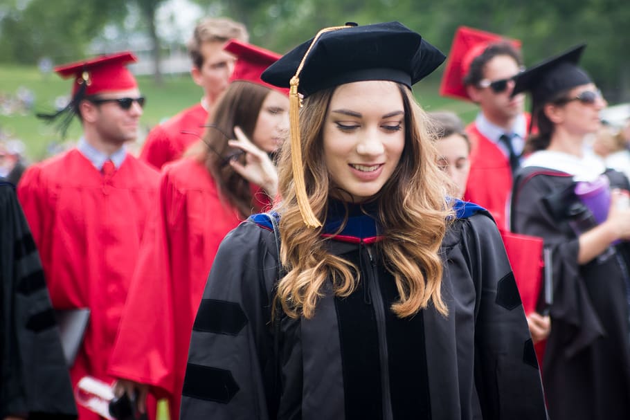 Smiling graduate in a gown and cap