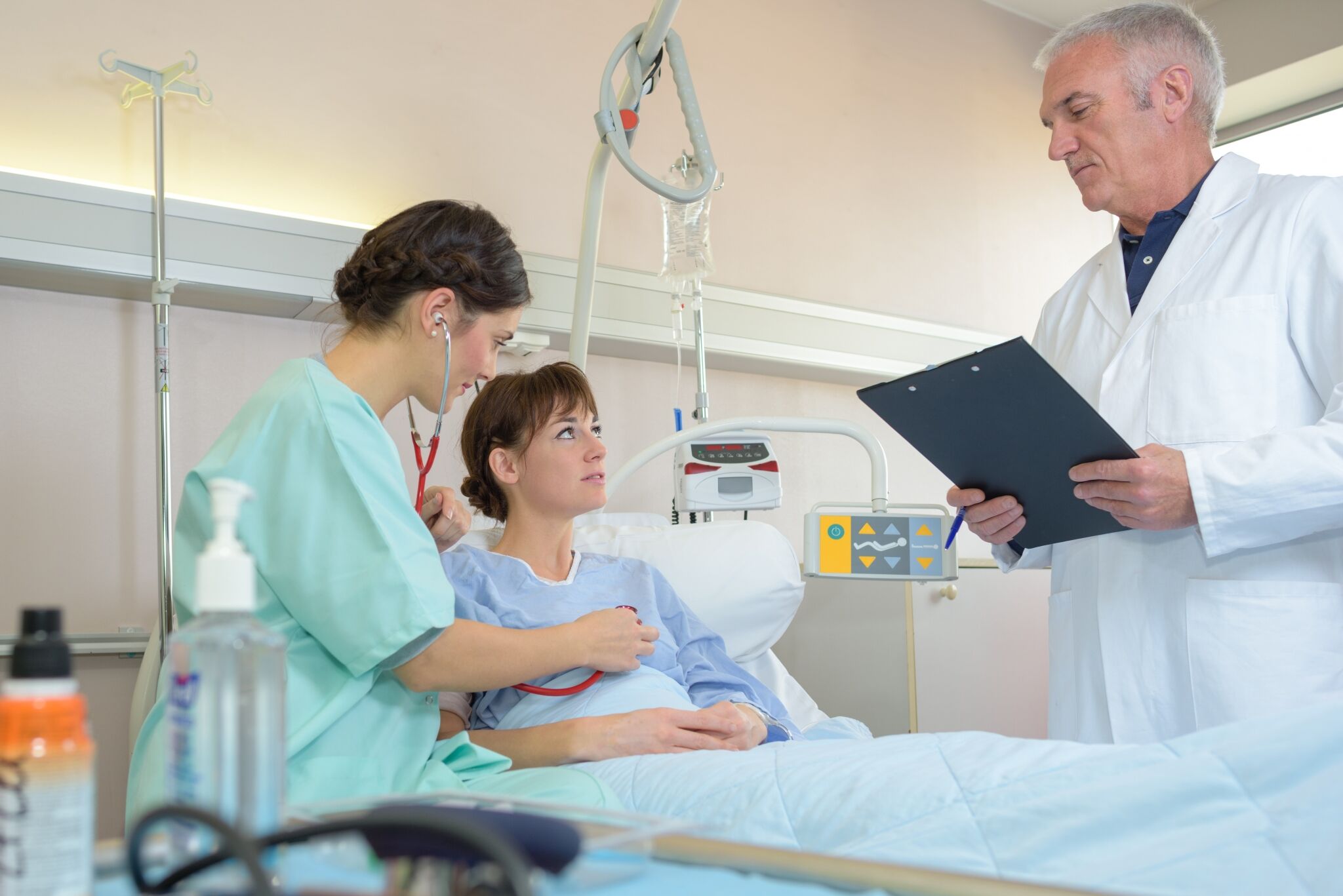 Doctor and Medical Assistant with a patient