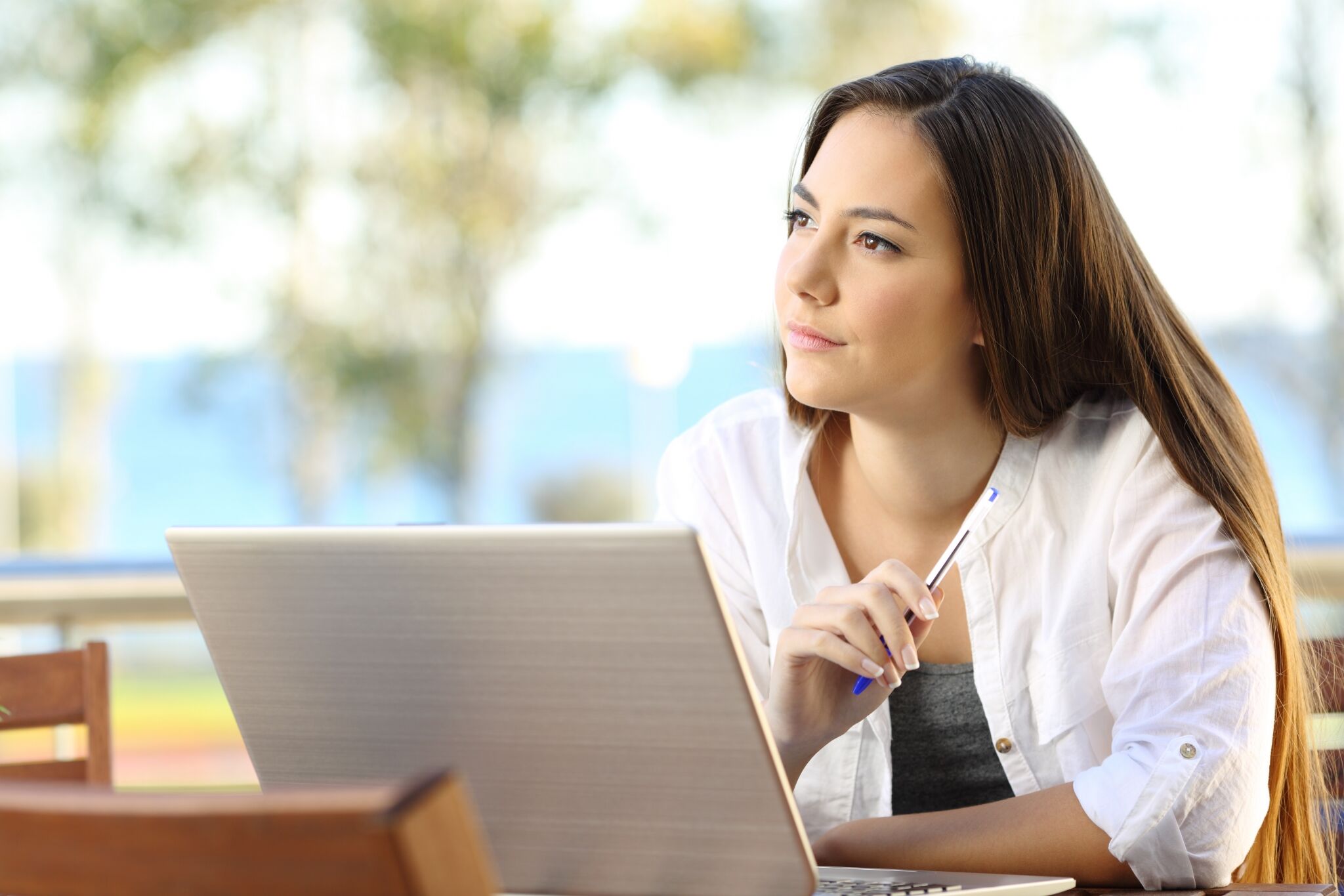 Woman on a laptop looking thoughtful