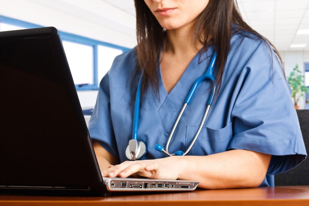 Close up of a medical professional on a laptop