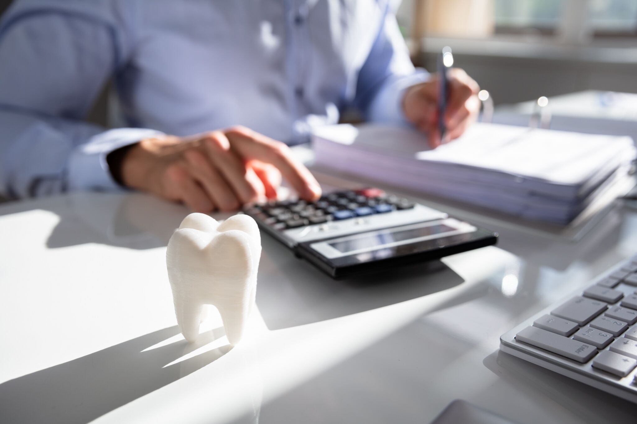 Close up of a tooth in front of an accountant