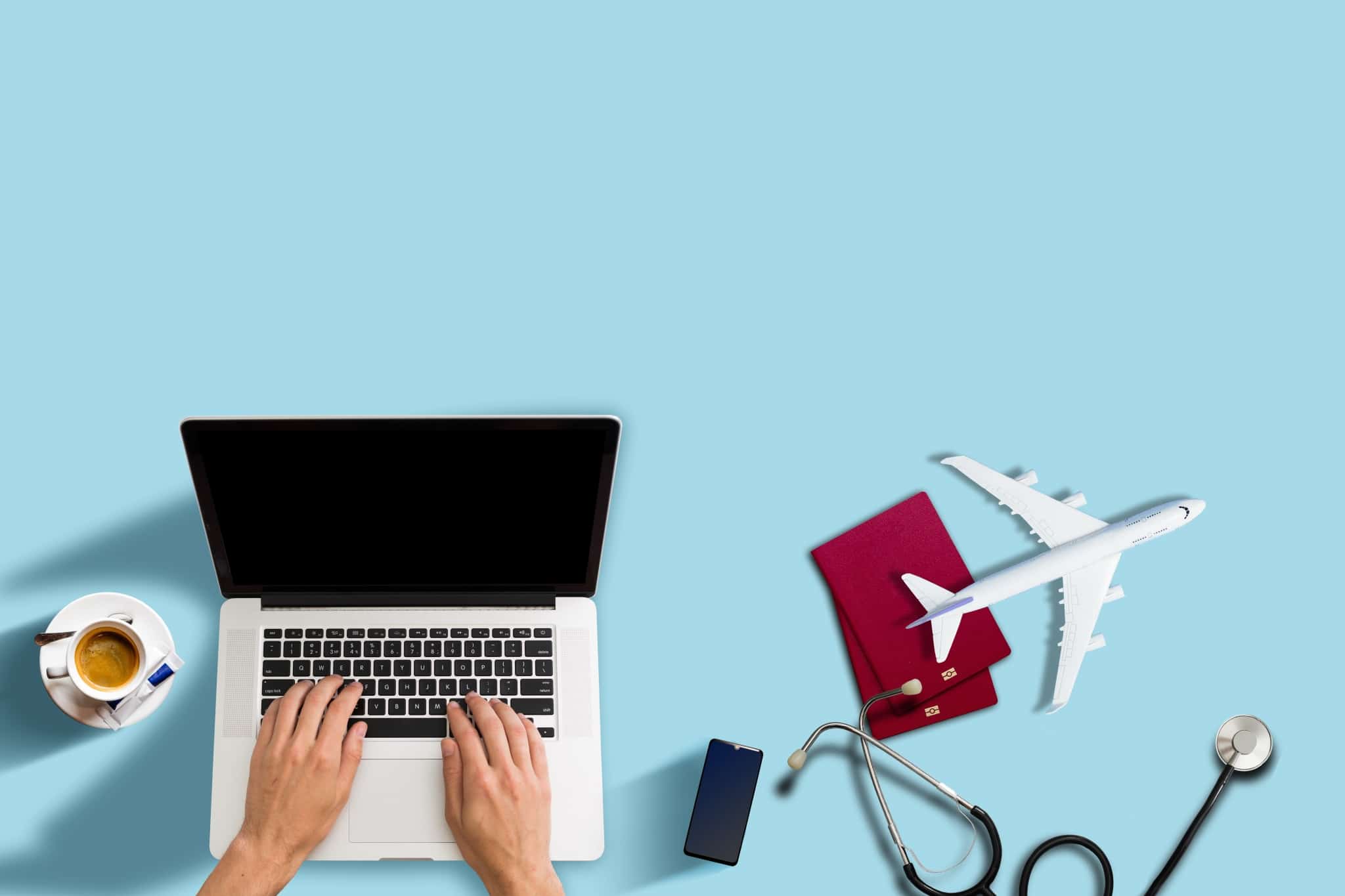 Travel nurse on a laptop with stethoscope and replica airplane