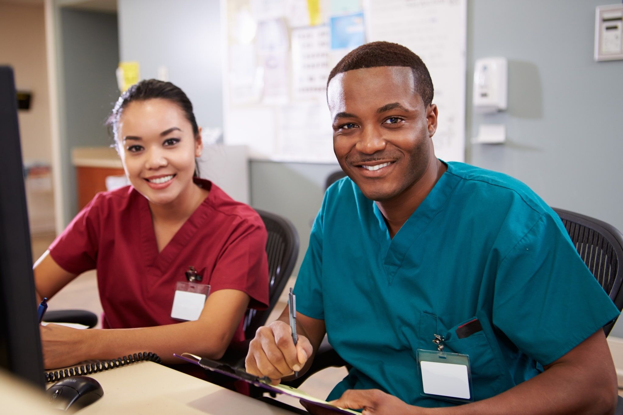 Male and female nurses working at a station