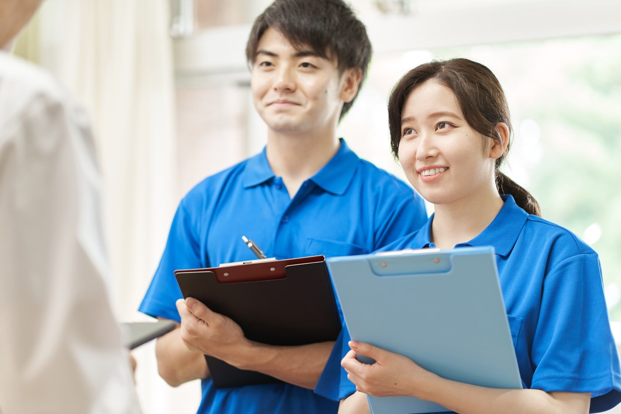 Two Asian nurses with clipboards