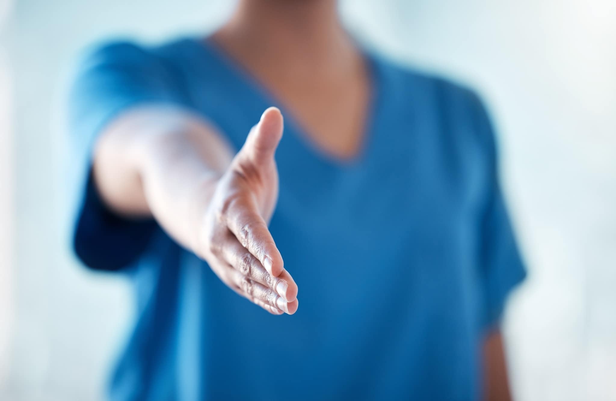 Close up of a nurse holding out her hand