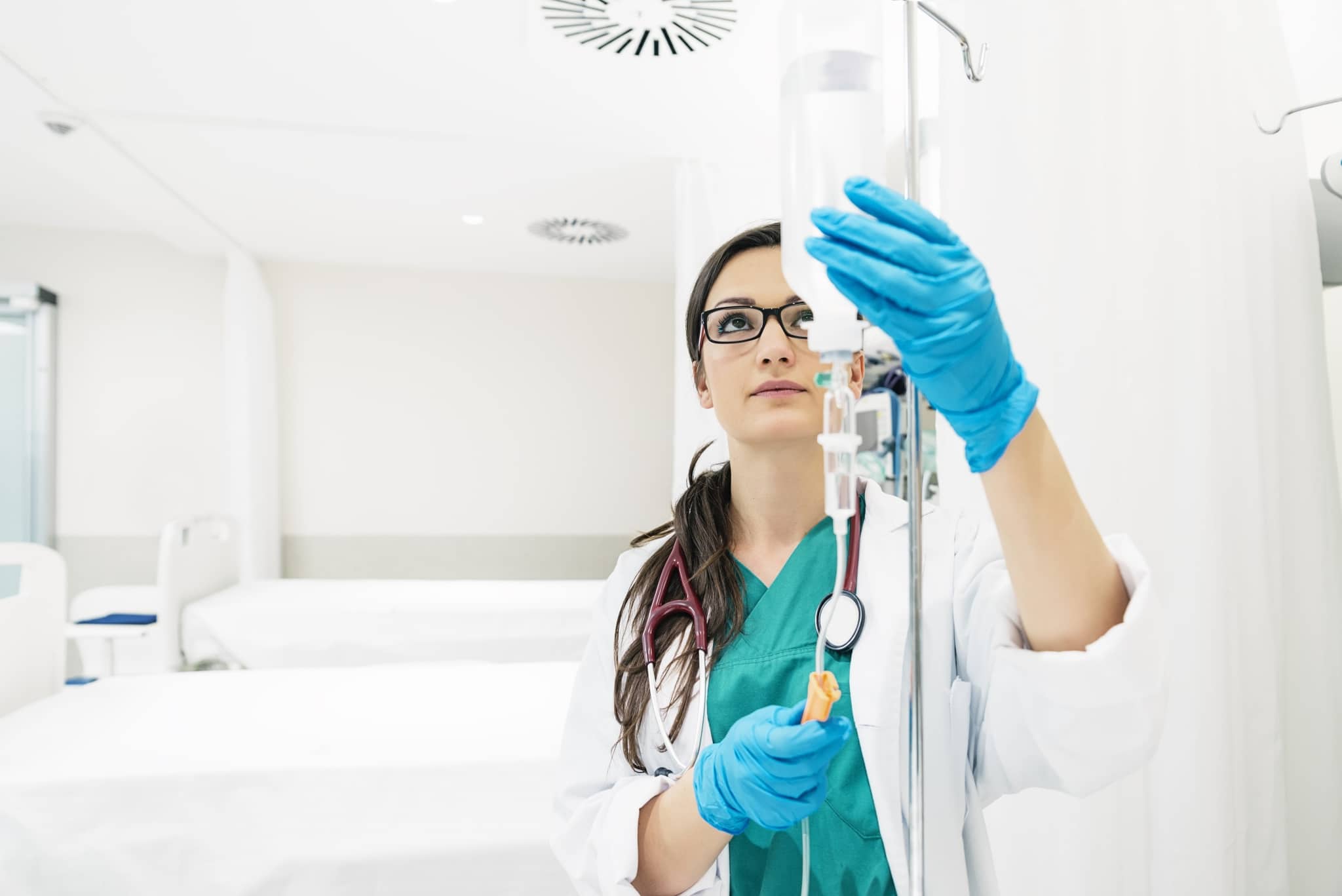 Young medical worker checking patient fluids