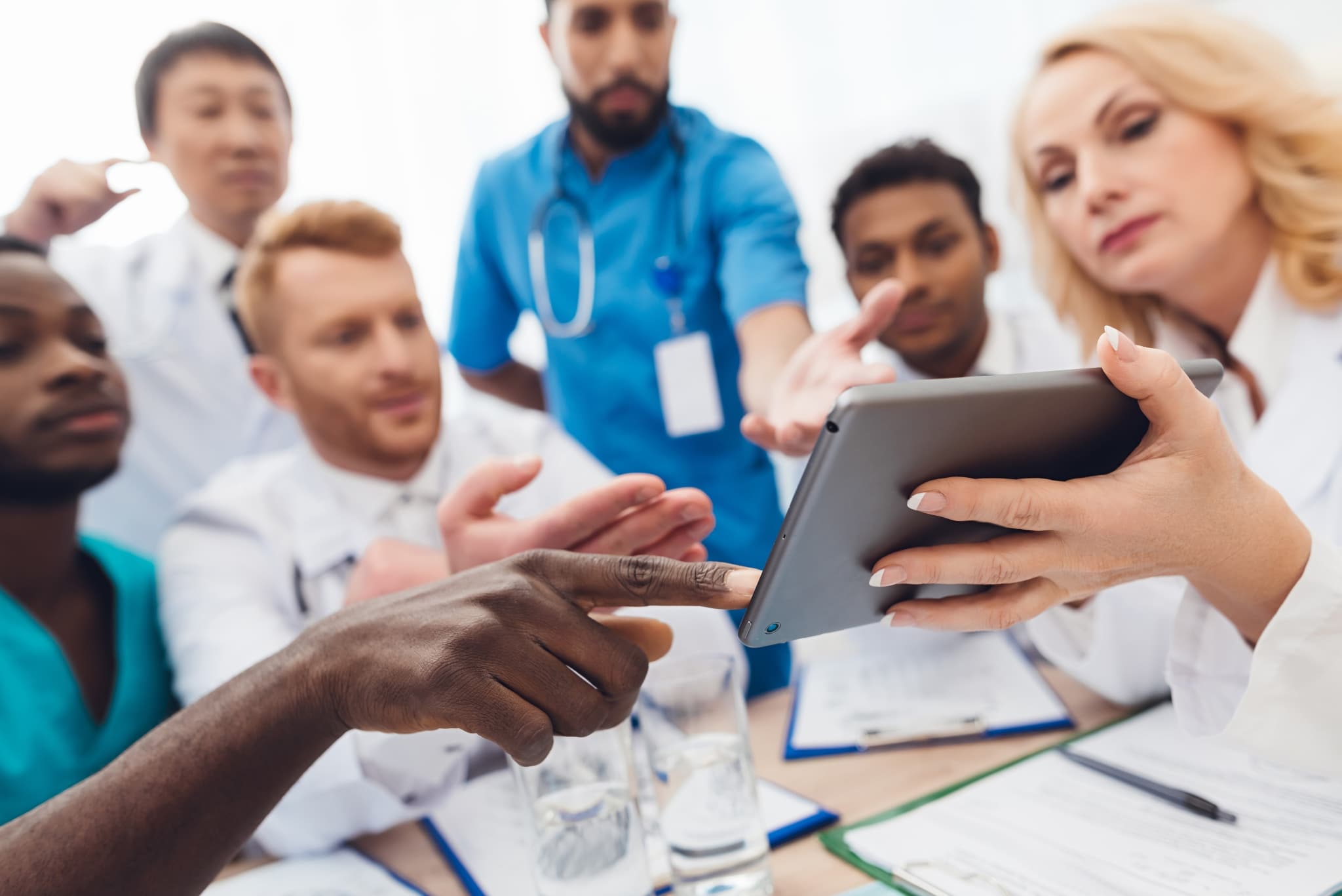 Group of medical professionals using a tablet