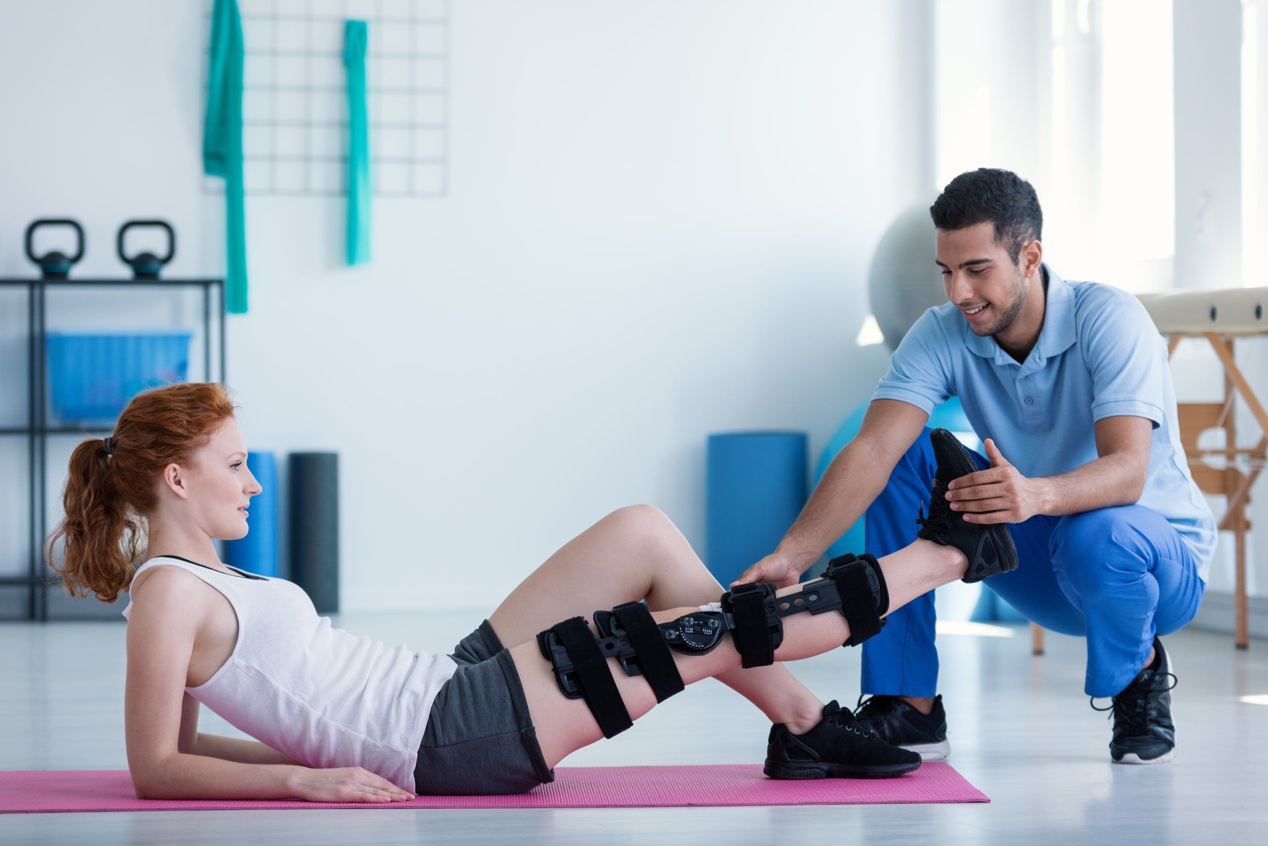 Physical Therapist Assistant with patient on a mat