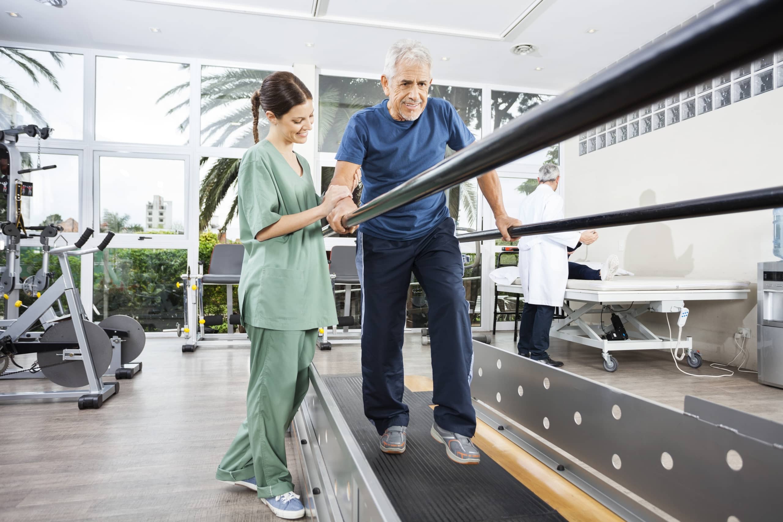 Physical Therapist Assistant with patient using bars