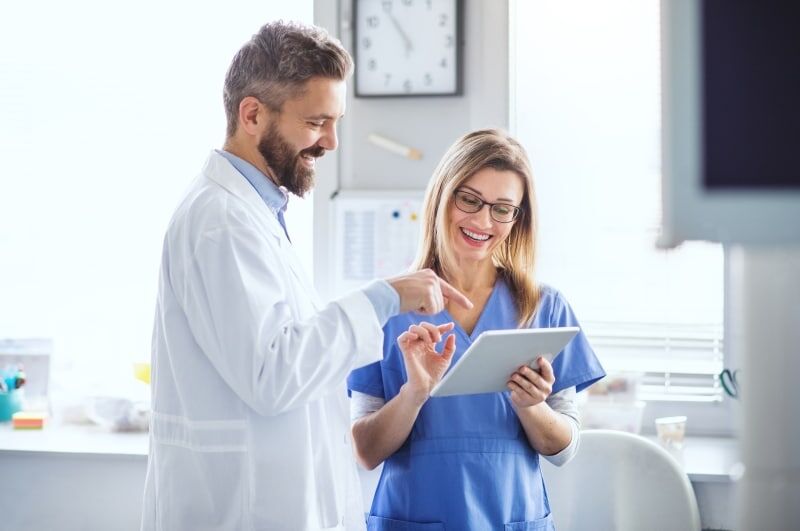 Dental professionals using a tablet in a modern clinic