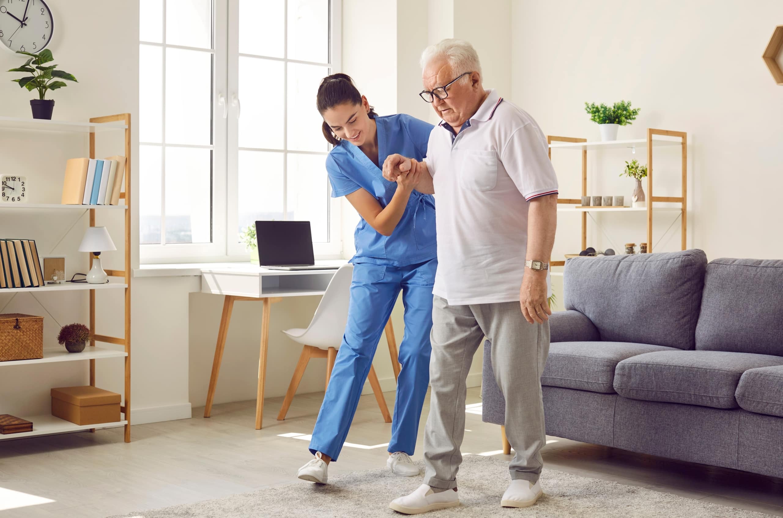 Nurse helping an elderly man walk