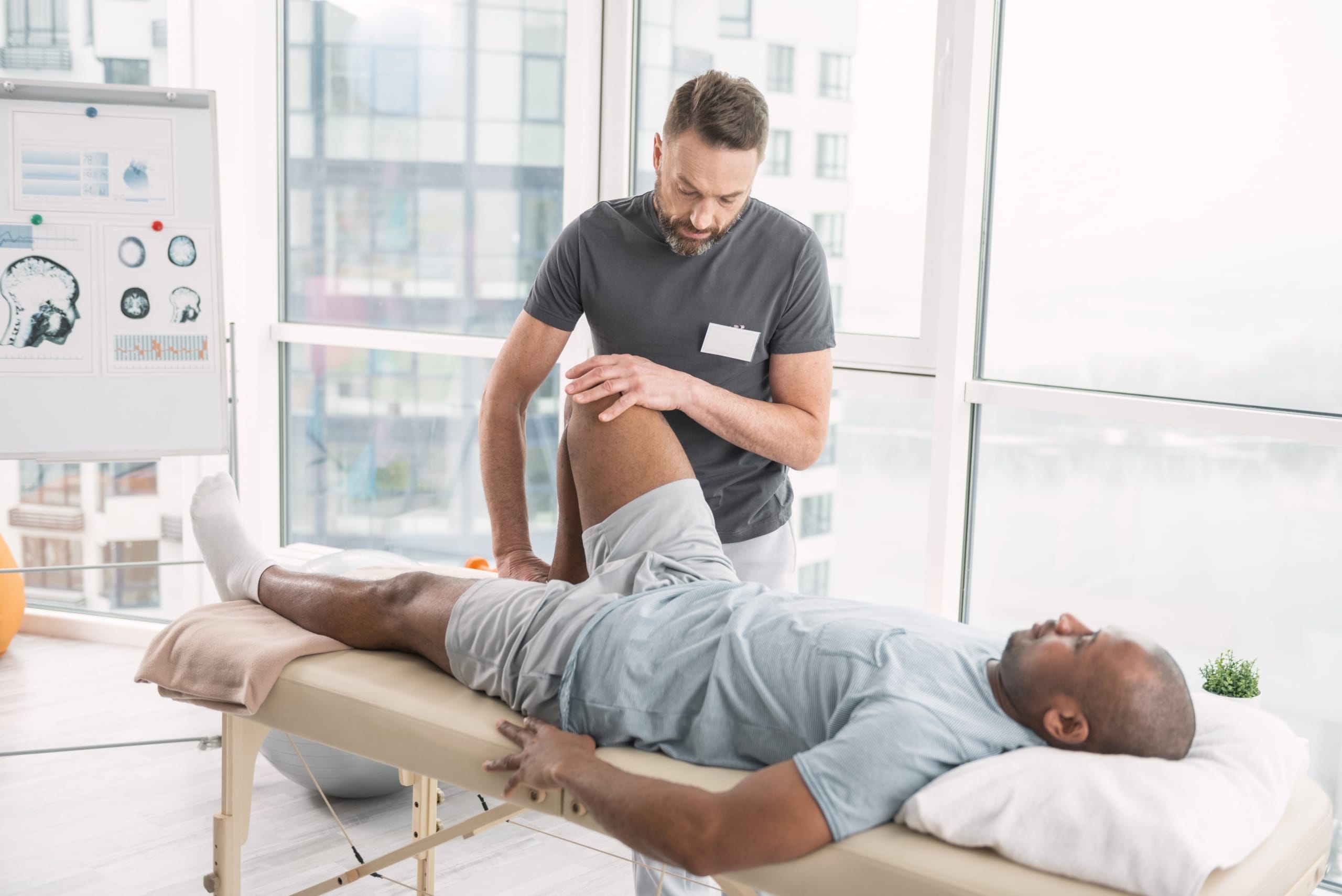 Physical therapy professional helping a patient