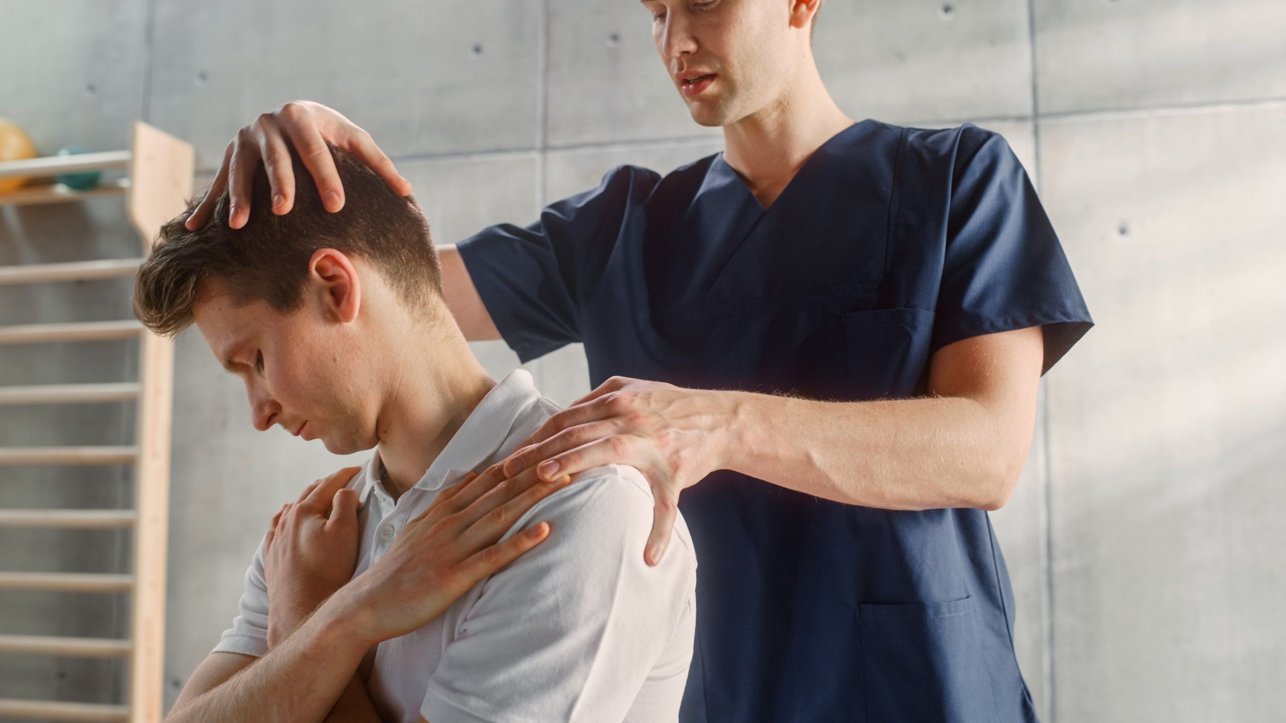 Physical therapy professional examining a man