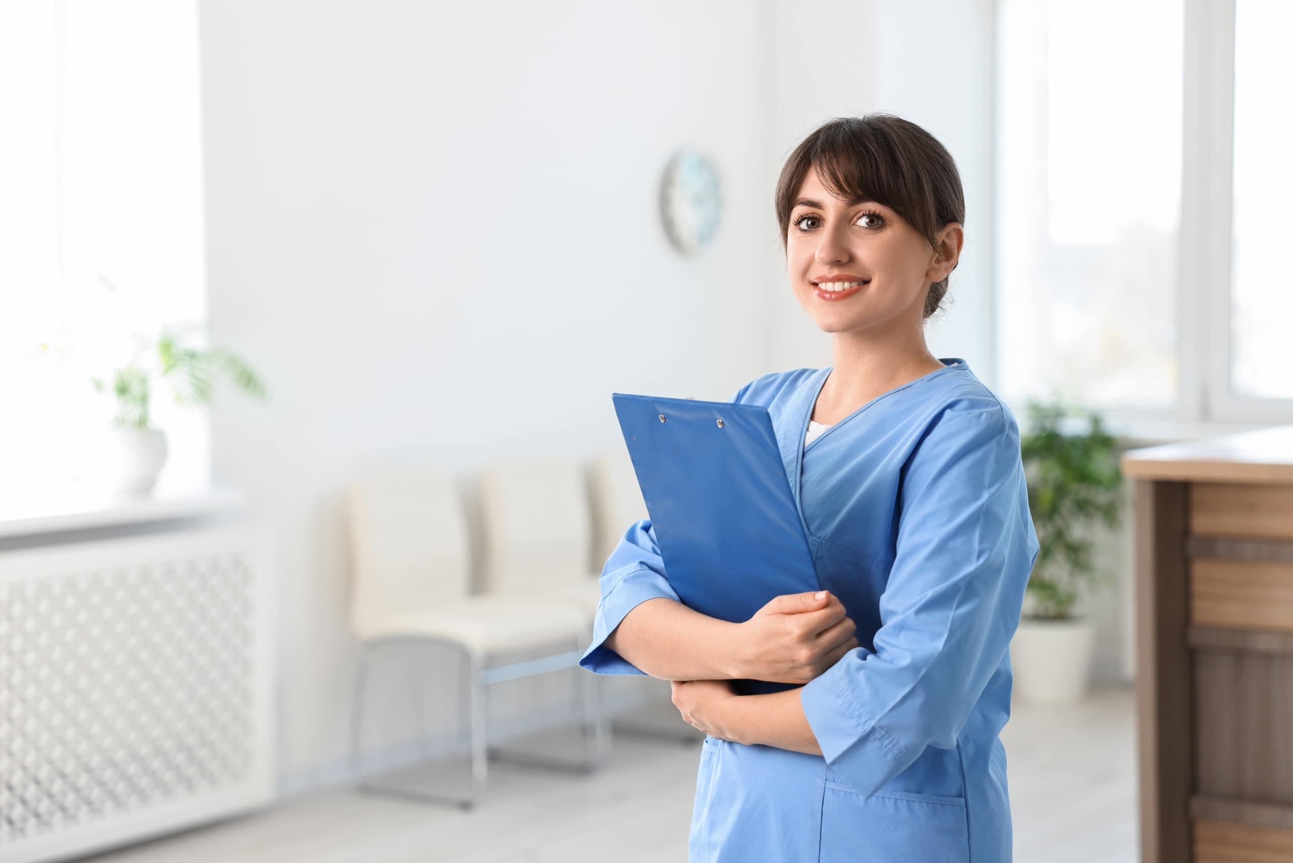 Portrait of a smiling medical professional with a clipboard in a hospital