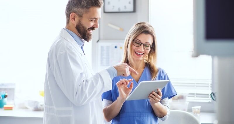 Dental professionals using a tablet in a modern clinic