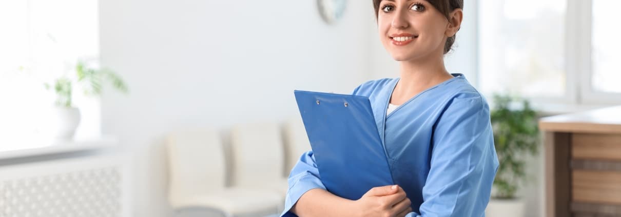 Portrait of a smiling medical professional with a clipboard in a hospital