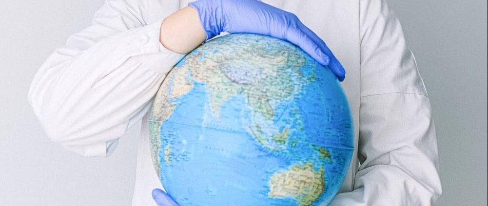 Nurse holding a globe