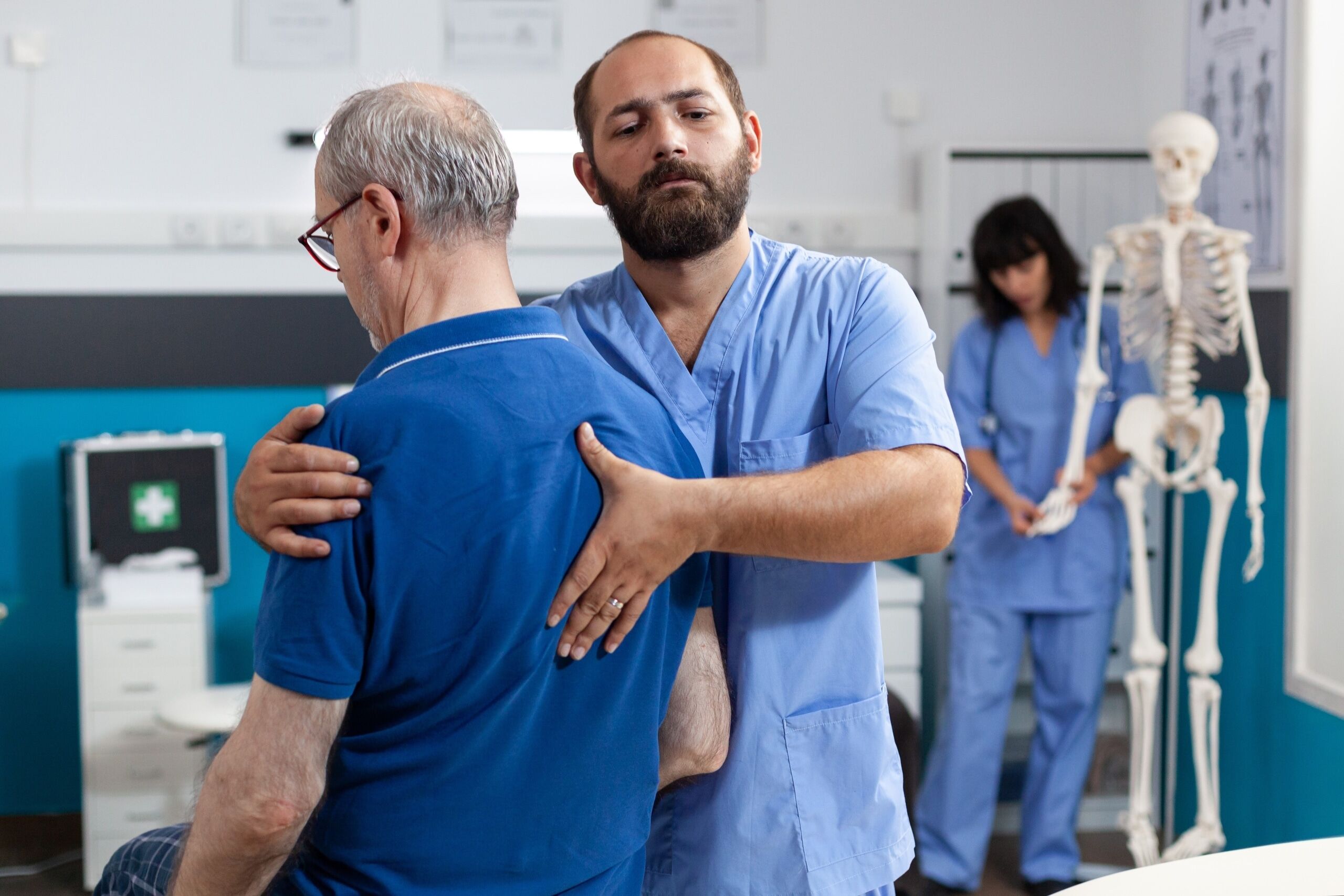 Male medical professional assisting a patient